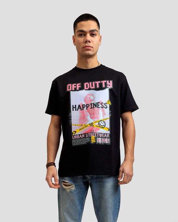 A close-up photo of a white Turkish look a like male model in a light grey backdrop wearing 'What Is Happiness' black relaxed t-shirt from Off Dutty's 'Rare and Radiant' collection, paired with striped jeans. He accessorizes with necklaces, three bracelets on his right hand.