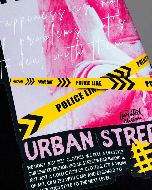 A Close-up photo of the 'What Is Happiness' black relaxed t-shirt from Off Dutty, focusing on the intricate details of the quote and design elements, highlighting the artistry of the tee.